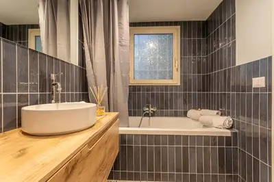 a bathroom with a tub and a sink at Ambra - Liberty Apartment at the Imperial Forums in Rome