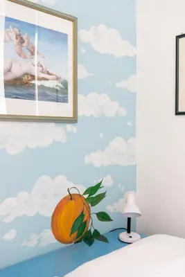an orange sitting on top of a bed in a bedroom at Grande appartamento a Trastevere in Rome
