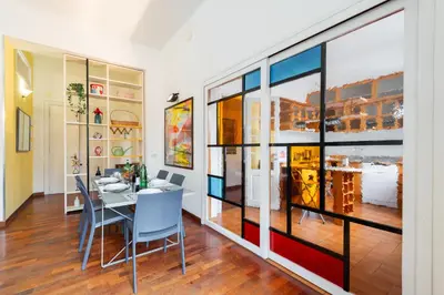 a dining room with a table and chairs at Grande appartamento a Trastevere in Rome