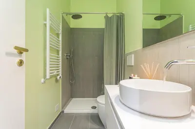 a bathroom with a sink and a toilet and a shower at Giada - Charming Apartment at the Imperial Forums in Rome