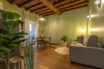 a living room with a couch and a table at Giada - Charming Apartment at the Imperial Forums in Rome