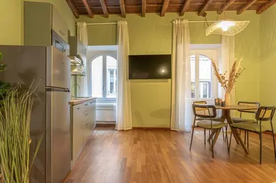 a kitchen with a table and a dining room at Giada - Charming Apartment at the Imperial Forums in Rome