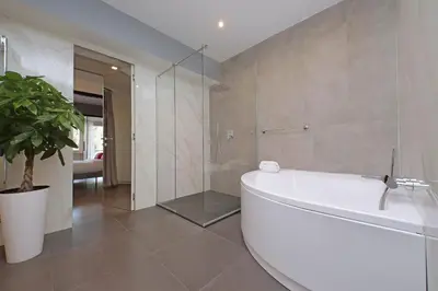 a bathroom with a tub and a glass shower at YCH-Exclusive apartment on Circus Maximus in Rome