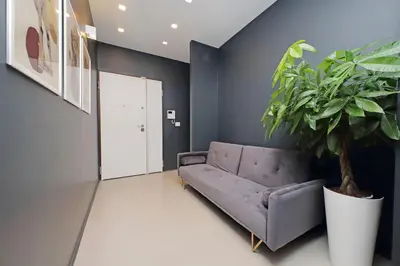 a living room with a purple couch and a potted plant at YCH-Exclusive apartment on Circus Maximus in Rome
