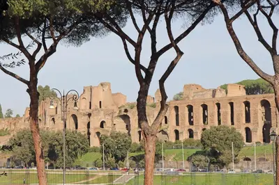 a large building with trees in front of it at YCH-Exclusive apartment on Circus Maximus in Rome