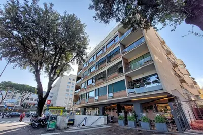 a tall building with a tree in front of it at YCH-Exclusive apartment on Circus Maximus in Rome