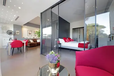 a bedroom with a bed and a table with flowers on it at YCH-Exclusive apartment on Circus Maximus in Rome