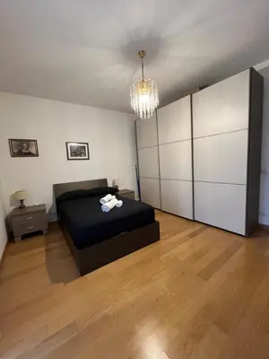 a large bedroom with a bed and a chandelier at Casa Conca D Oro in Rome