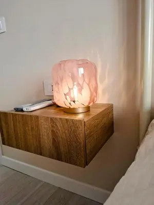 a pink lamp sitting on top of a wooden table at Appartamento Aurelio in Rome