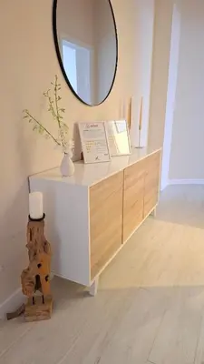 a white dresser with a mirror on top of it at Appartamento Aurelio in Rome