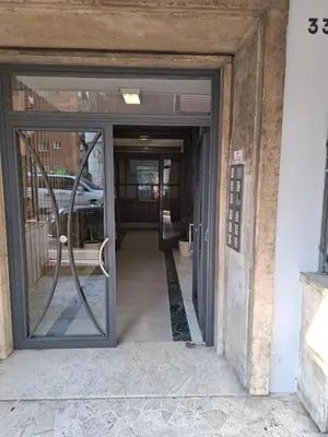 an entrance to a building with a revolving door at Appartamento Aurelio in Rome