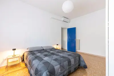 a bedroom with a bed and a blue door at Grazioso appartamento a Roma San Paolo in Rome