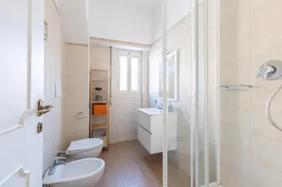 a bathroom with a toilet and a sink and a shower at Grazioso appartamento a Roma San Paolo in Rome