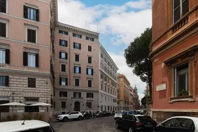 a city street with parked cars and buildings at GuestHost - Historic Apartment in Sallustiano in Rome