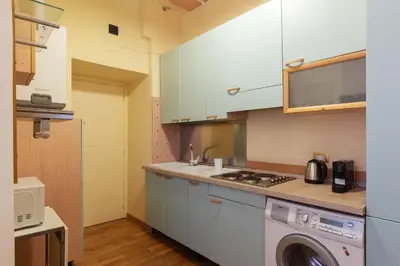 a kitchen with a washer and a washing machine at GuestHost - Historic Apartment in Sallustiano in Rome
