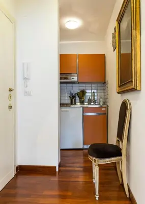 a kitchen with a chair and a table and a counter at FCR Rome Apartments Loft Campo de' Fiori - Monserrato in Rome