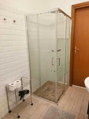 a glass shower in a bathroom with a sink at Casa Flegrei in Rome