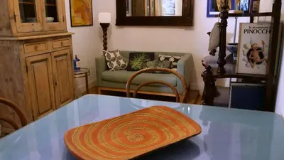 a glass table in a living room with a couch at Cozy artsy apt near the Vatican in Rome