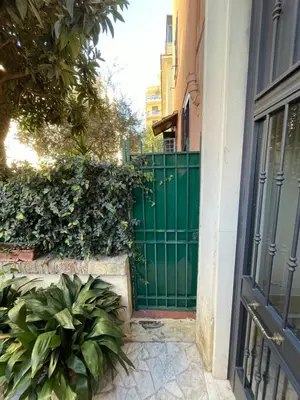 an entrance to a building with a green gate at Cozy artsy apt near the Vatican in Rome