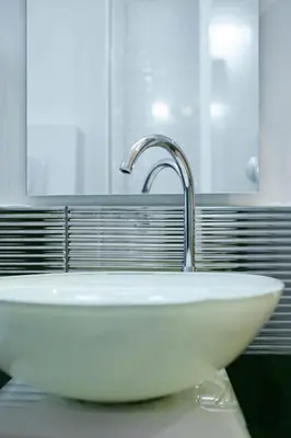 a white sink in a bathroom with a faucet at Lorenzo's Rooms in Vatican in Rome