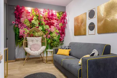 a living room with a large wall of flowers at Mabi - Roma San Paolo Centro in Rome