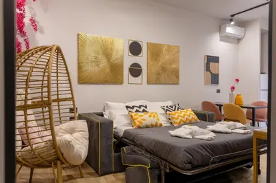 a living room with a bed and a chair at Mabi - Roma San Paolo Centro in Rome