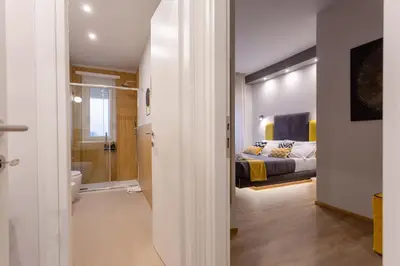 a bedroom with a bed and a bathroom at Mabi - Roma San Paolo Centro in Rome