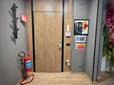 a fire hydrant in front of a wooden door at Mabi - Roma San Paolo Centro in Rome