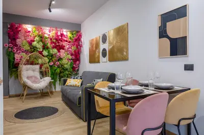 a living room with a couch and a table and flowers at Mabi - Roma San Paolo Centro in Rome