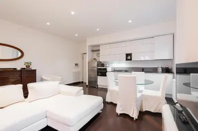 a living room with a white couch and a table at The Vatican Rest, Elegant Apt Nerby the Basilica in Rome