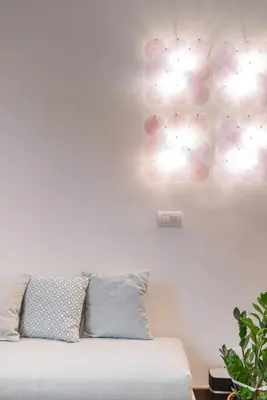 a room with a couch and lights on the wall at The Vatican Rest, Elegant Apt Nerby the Basilica in Rome