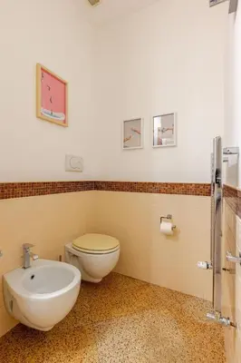 a bathroom with a toilet and a sink at Casa Maddalena luxury appartment in Rome