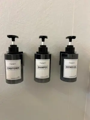 a group of three bottles of soap on a wall at Casa Maddalena luxury appartment in Rome