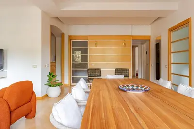 a living room with a large wooden table and chairs at Casa Maddalena luxury appartment in Rome