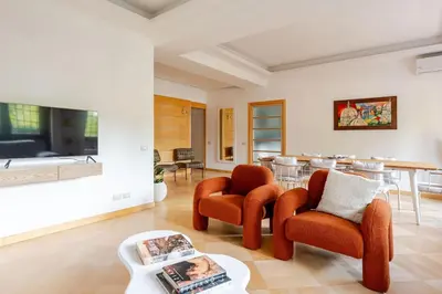 a living room with two chairs and a table at Casa Maddalena luxury appartment in Rome