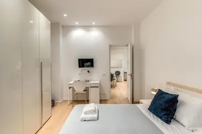 a bedroom with a bed and a desk in a room at Residenza Margherita in Rome
