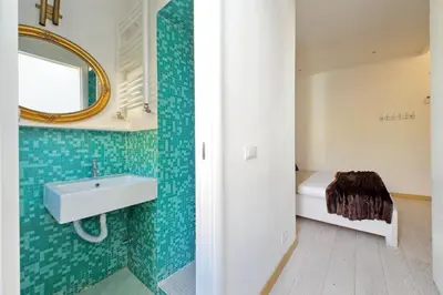 a bathroom with a sink and a mirror at Colosseo Attico Particolare Terrazza Panoramica in Rome
