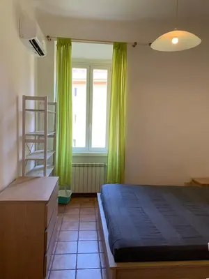 a bedroom with a bed and a ladder and a window at Flat nearby Vaticano - Caracciolo 4 in Rome