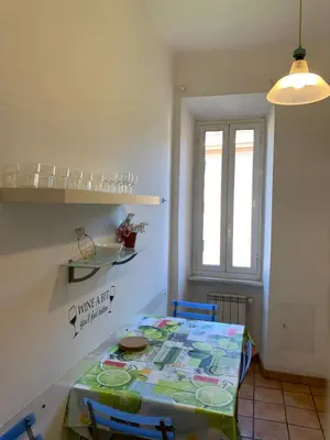 a dining room with a table and chairs and a window at Flat nearby Vaticano - Caracciolo 4 in Rome