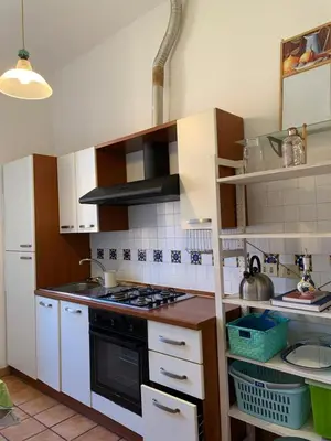 a kitchen with white cabinets and a stove top oven at Flat nearby Vaticano - Caracciolo 4 in Rome
