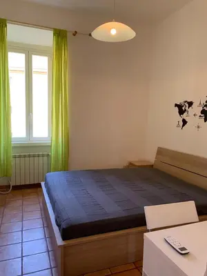 a bedroom with a bed with green curtains at Flat nearby Vaticano - Caracciolo 4 in Rome