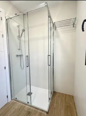 a shower stall with a glass door in a bathroom at Il CIGNO in Rome