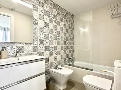 a bathroom with a toilet and a sink and a tub at Il CIGNO in Rome