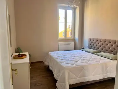 a bedroom with a bed and a window at Fast Re Apartment in Rome