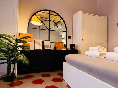 a room with two beds and a potted plant at Hexa in Rome