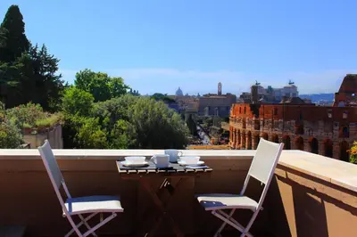 a table and chairs on a balcony with a view at Hexa in Rome
