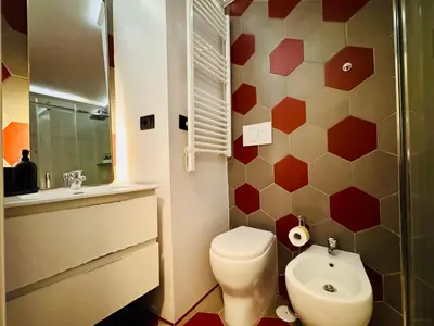 a bathroom with a toilet and a sink at Hexa in Rome