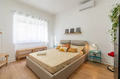 a bedroom with a large bed in a room at Gemelli Apartment in Rome