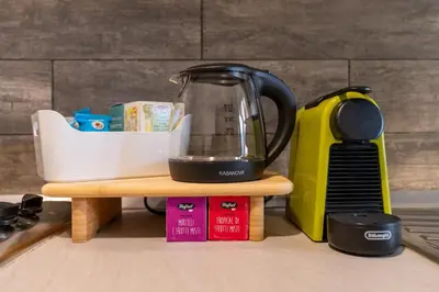 a black tea kettle sitting on a counter next to a blender at Gemelli Apartment in Rome