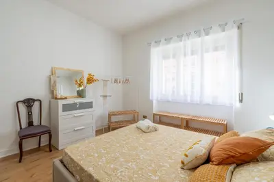 a bedroom with a bed and a dresser and a window at Gemelli Apartment in Rome